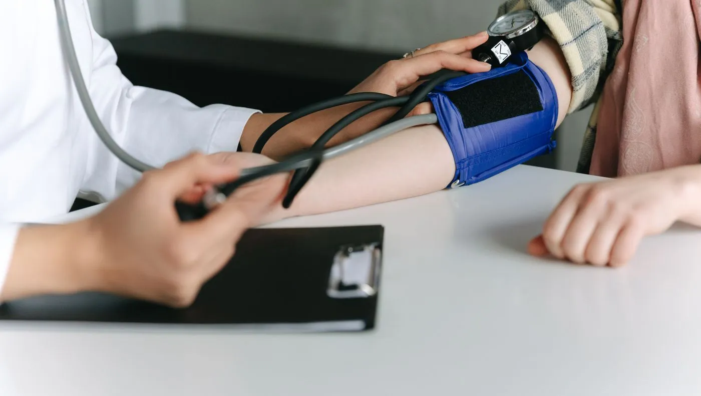 A blood pressure cuff being used on a patient's arm