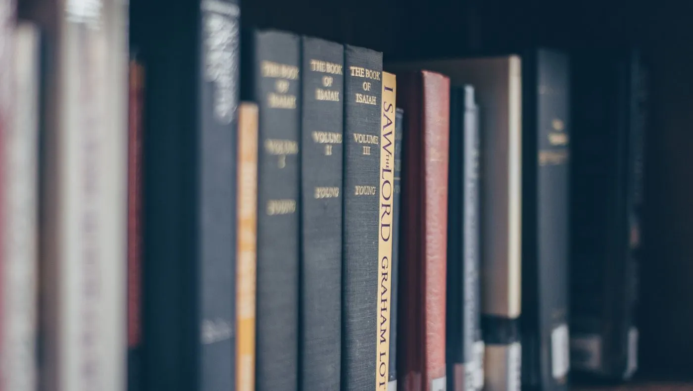 A row of medical reference books on a shelf