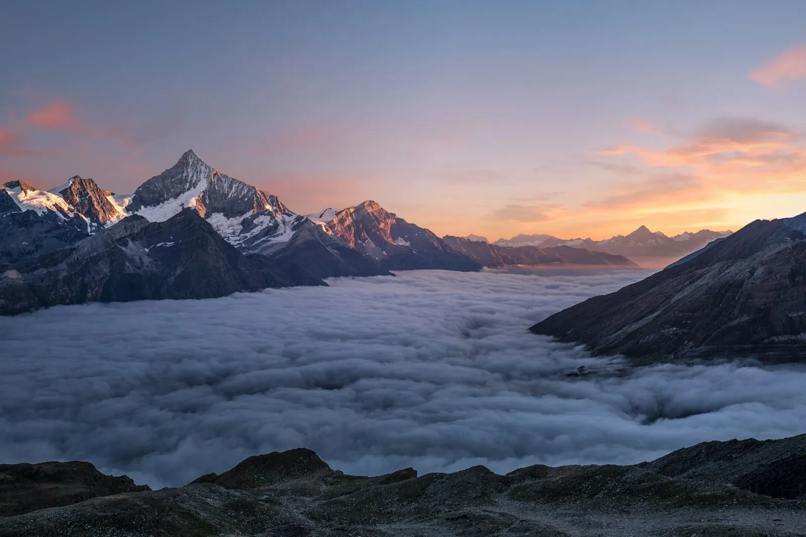 Hiker watching sunrise over mountain peaks after a long climb, the payoff NoFap benefits promise