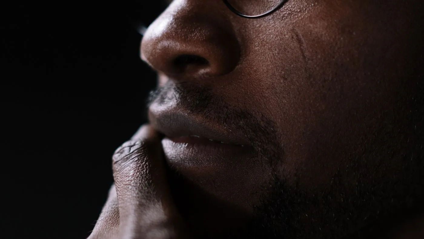 A person deep in thought in low light