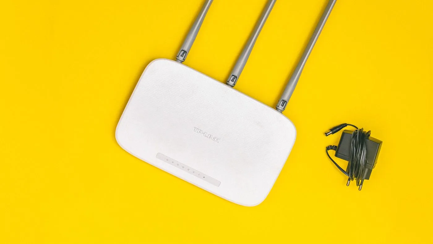 A white wifi router on a plain background
