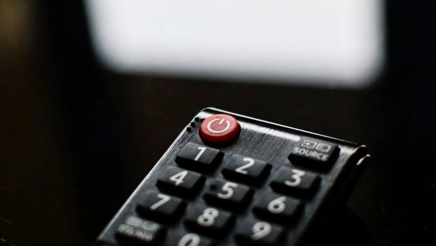 A television remote resting on a table