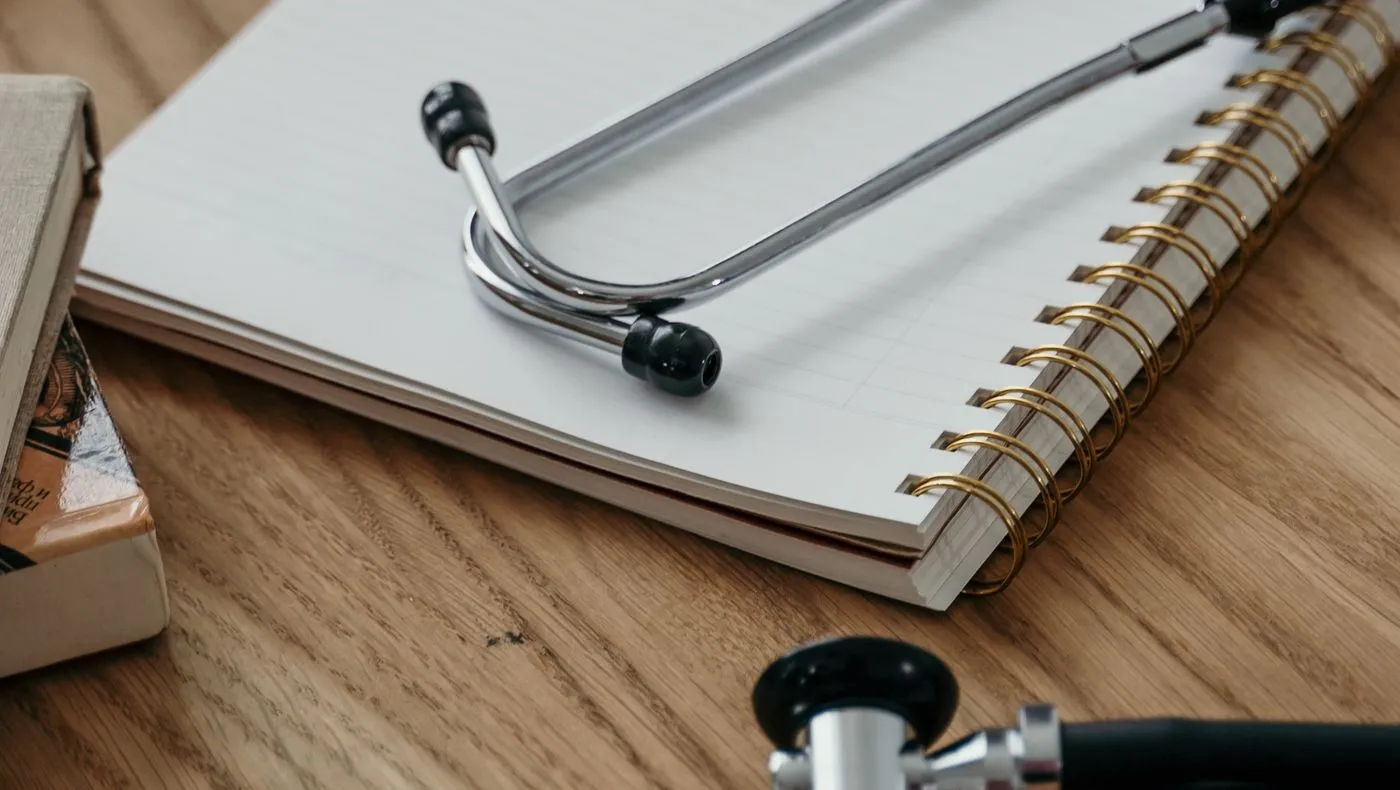 A stethoscope resting on a notebook
