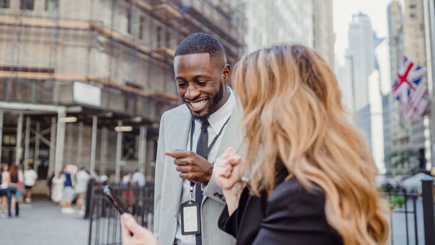 Two people talking on a city street