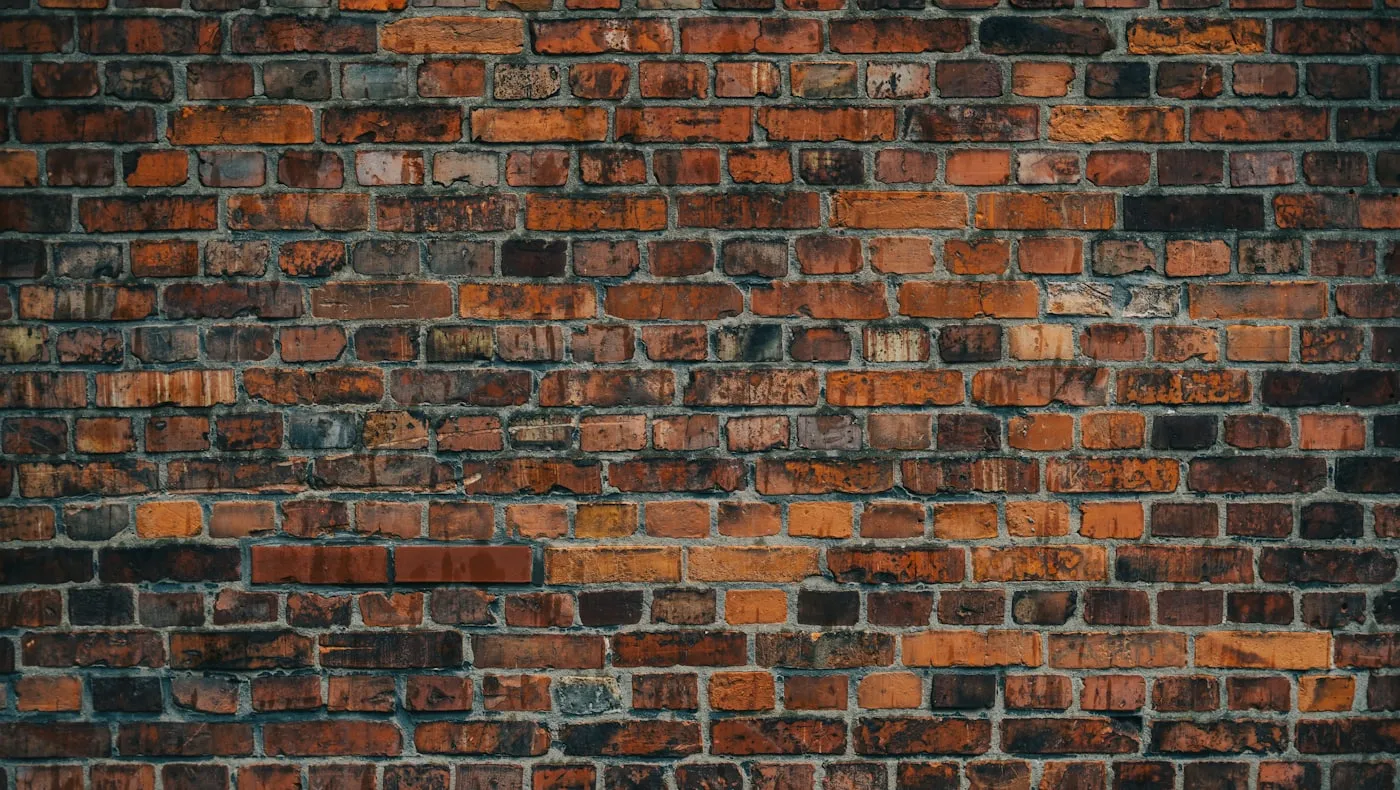A dark brick wall filling the frame