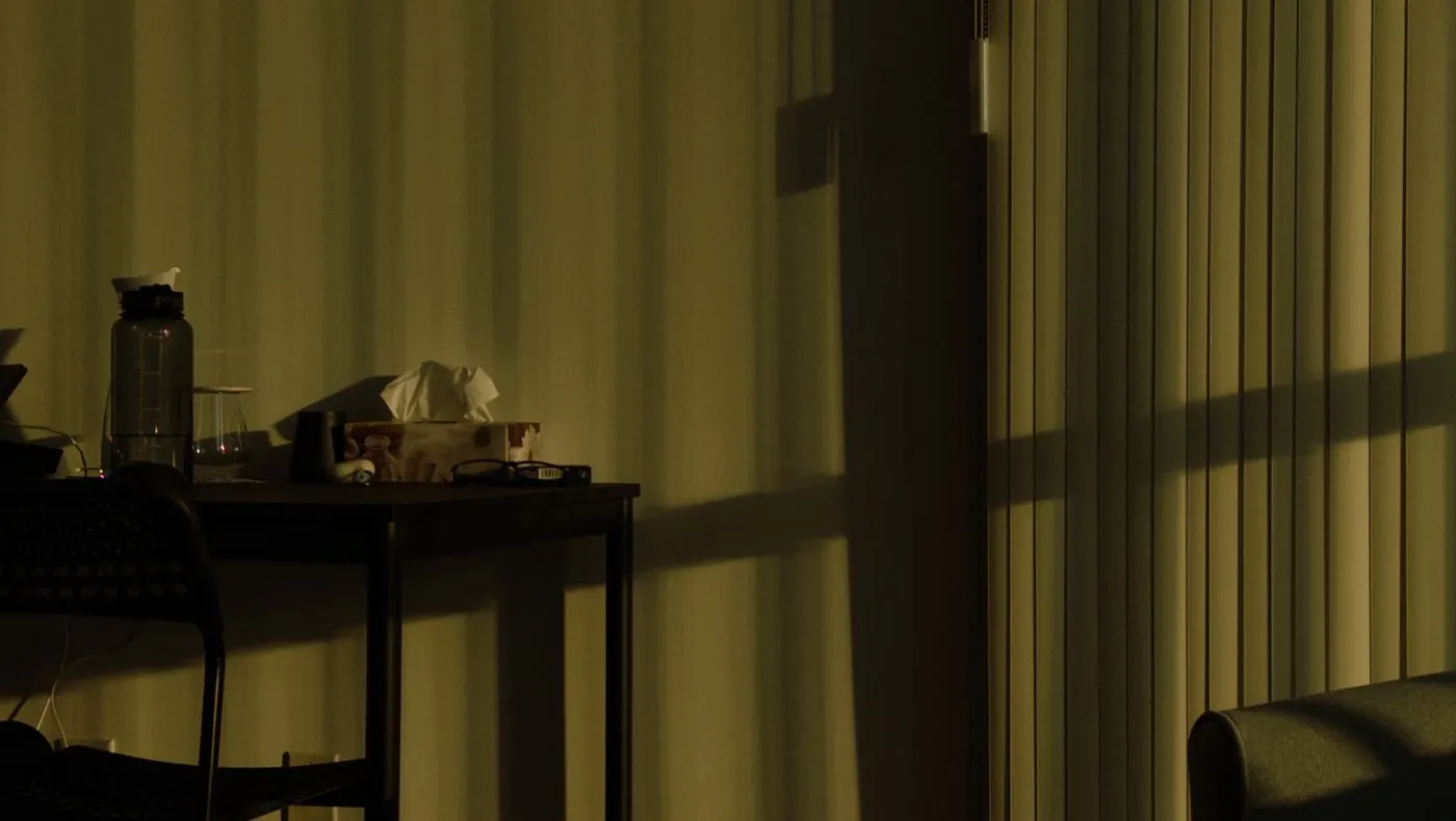 A dim living room lit by a screen