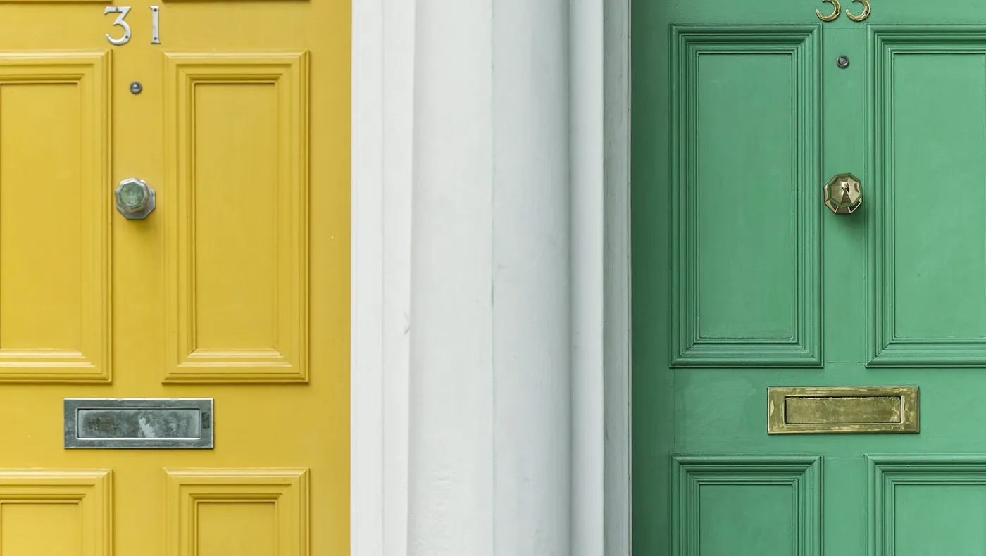 Two painted front doors side by side