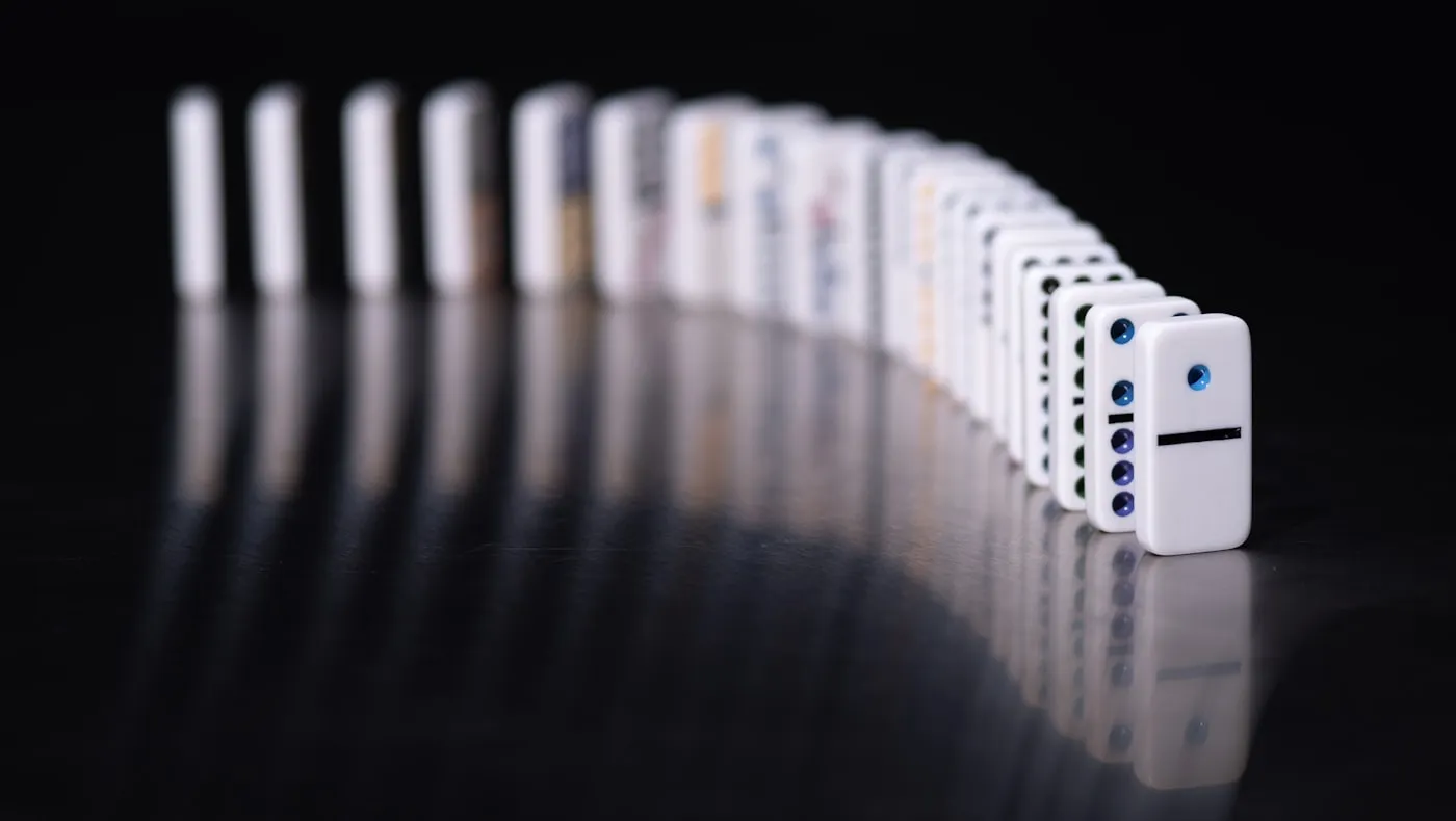 A line of dominoes mid fall