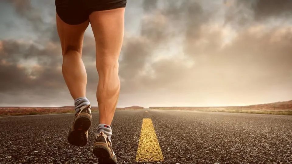 A man running alone on an open road