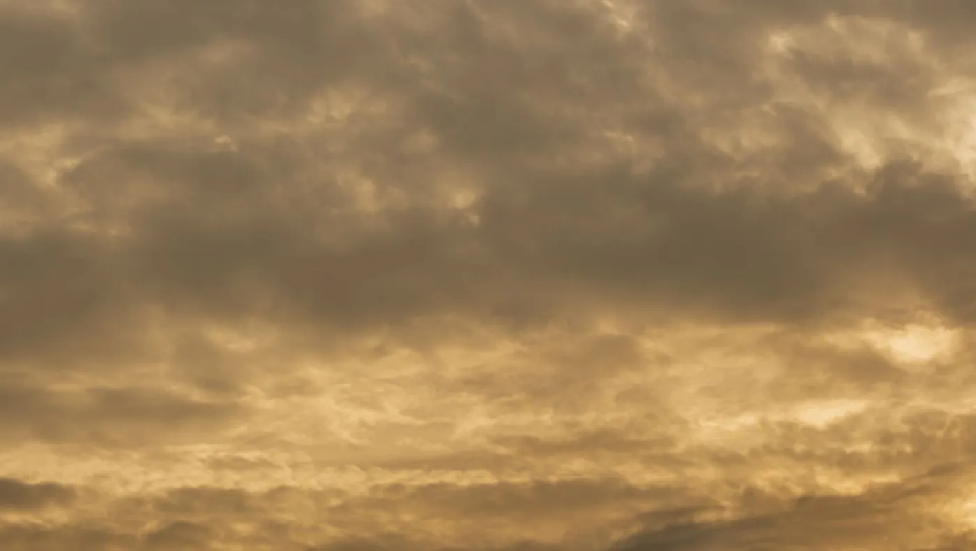 Heavy clouds lit from behind at dusk